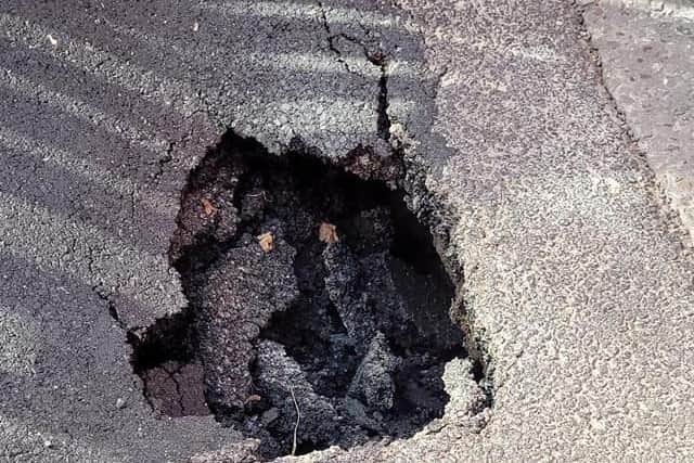 Two potholes like this are being filled in Lumley Road. Photo: Barry Robinson.
