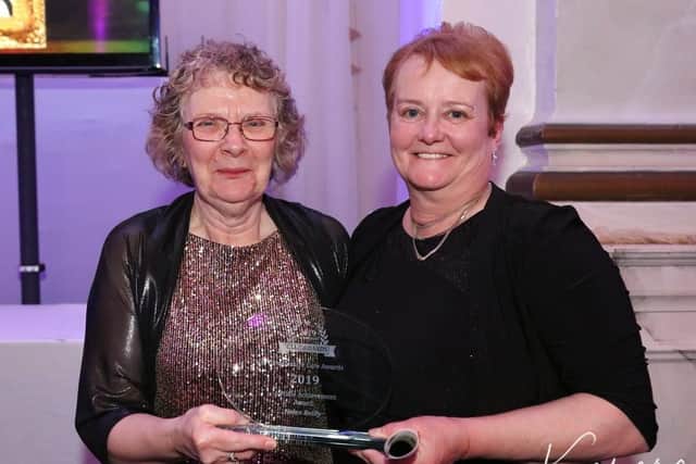 Helen Reilly (left) receiving her lifetime achievement award. (Kamara photo). EMN-200303-102721001