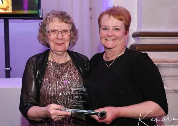 Helen Reilly (left) receiving her lifetime achievement award. (Kamara photo). EMN-200303-102721001