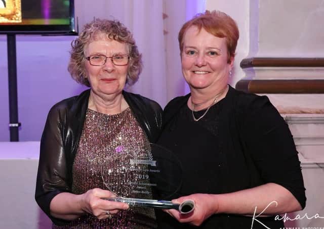 Helen Reilly (left) receiving her lifetime achievement award. (Kamara photo). EMN-200303-102721001