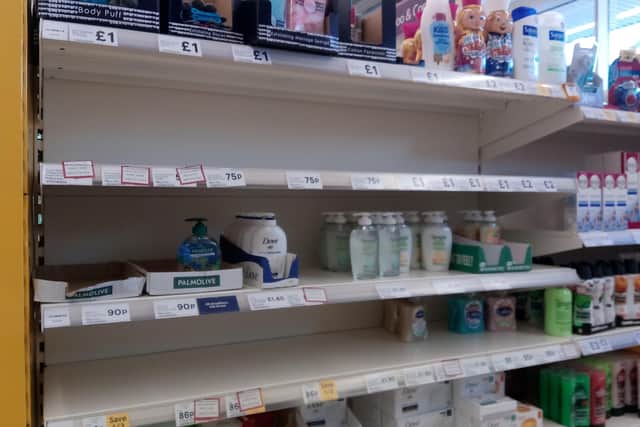Sanitising sales shelves at Rasen's Tesco store