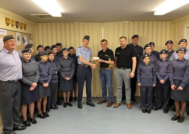 Andrew Lyle and Richard Cameron from the Round Table present the cheque to Flt Lt Mike Eckersley RAFAC, OC 2292 (Market Rasen) Sqn