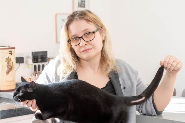 Eve Johnson with Pixie and his damaged tail which she says was caused by someone deliberately shaving it. Picture: John Aron Photography.