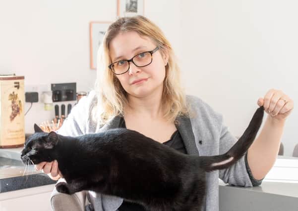 Eve Johnson with Pixie and his damaged tail which she says was caused  by someone deliberately shaving it. Picture: John Aron Photography.