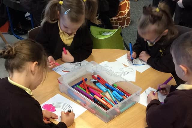 Pupils at the Richmond School in Skegness colouring rainbows.