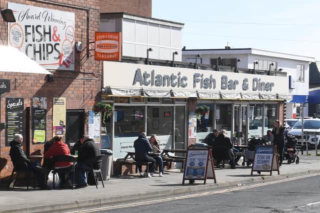 Visitors seated outside the Atlantic Fish Bar and Diner in Skegness on Saturday March 21, 2020.