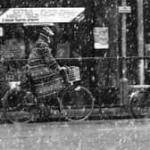 Cyclists, braving the elements.