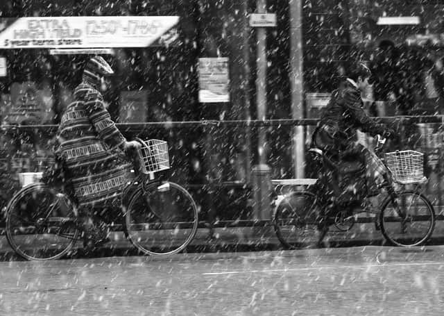 Cyclists, braving the elements.