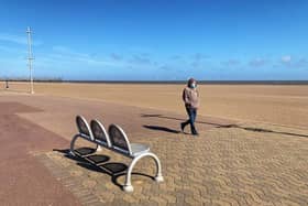 A lone walker wearing a mask on Skegness beach. Photo: John Byford.