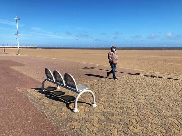 A lone walker wearing a mask on Skegness beach. Photo: John Byford.