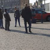 Police talk to a group gathered in the Market Place last week