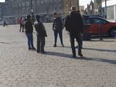Police talk to a group gathered in the Market Place last week