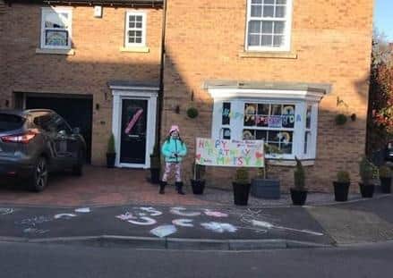 Rhiannon outside her home at Greylees with the poster and messages that attracted passers by. EMN-200304-104020001