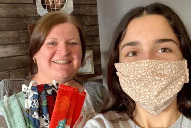 Teresa Addison with some of the face masks, alongside her 14-year-old daughter Ebony.