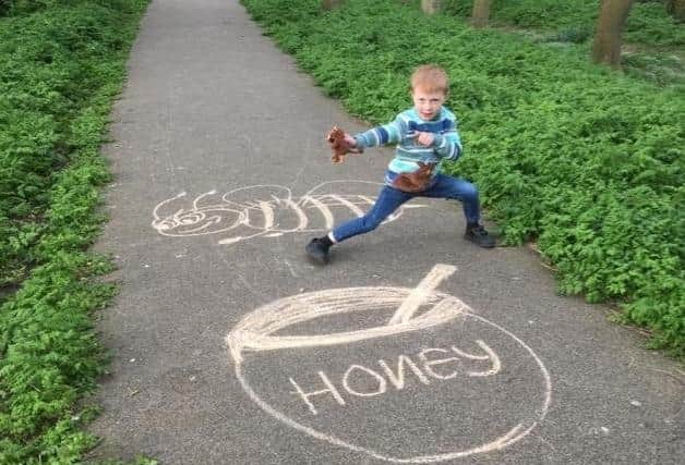 Harry Walters enjoying a game created by his mum, Sally, in Vine Walk, Skegness.