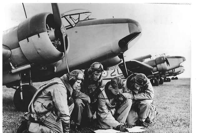 Cadets with one of the college's old training aircraft, an Airspeed Oxford. EMN-201004-130626001