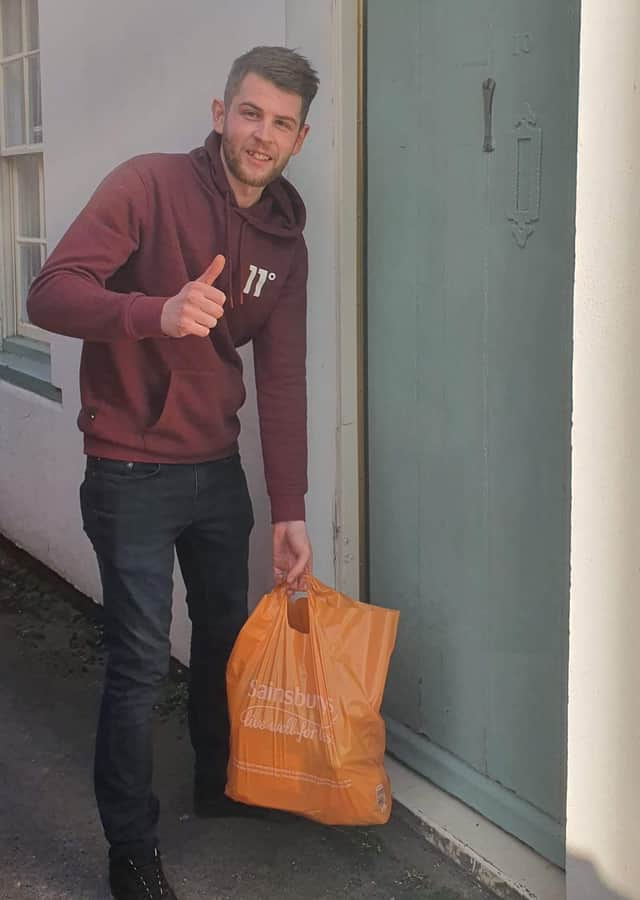Volunteer Jordan Wilson delivering some shopping. ANL-200413-110349001