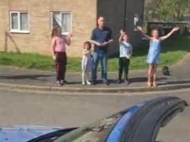 A family waving to the Easter bunny.
