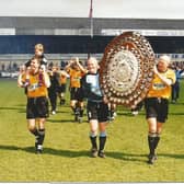 Paul Bastock and David Rennie parade the Dr Martens shield.