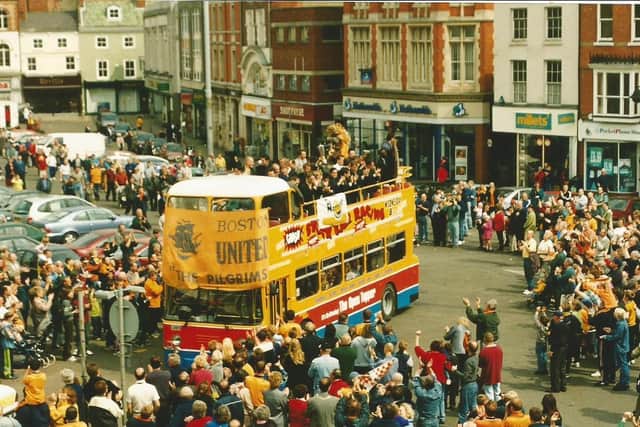 Fans greet United on their open-top bus parade.