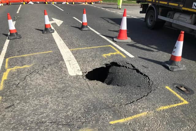 The hole beneath this road collapse is eight feet deep, say police.