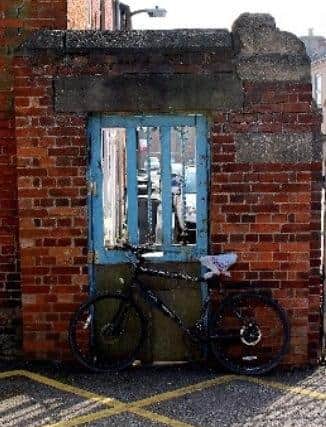 An old bike against a worn gate structure was by Aimee Scadding. EMN-200417-104758001
