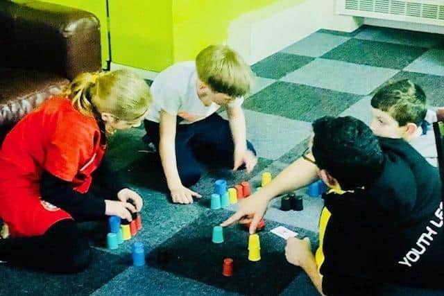 Photo of James with young people enjoying a game, prior to the coronavirus outbreak.