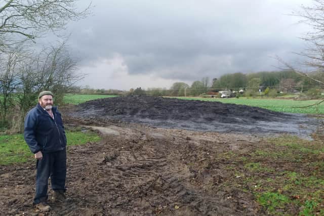 Farmer Gordon Stanley near the heap