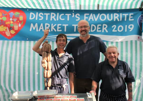 Mick Edwards (right) with his nephew and colleague Mark Loughran at their market stall last summer, alongside ELDC leader Craig Leyland.
