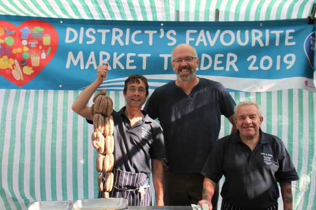 Mick Edwards (right) with his nephew and colleague Mark Loughran at their market stall last summer, alongside ELDC leader Craig Leyland.