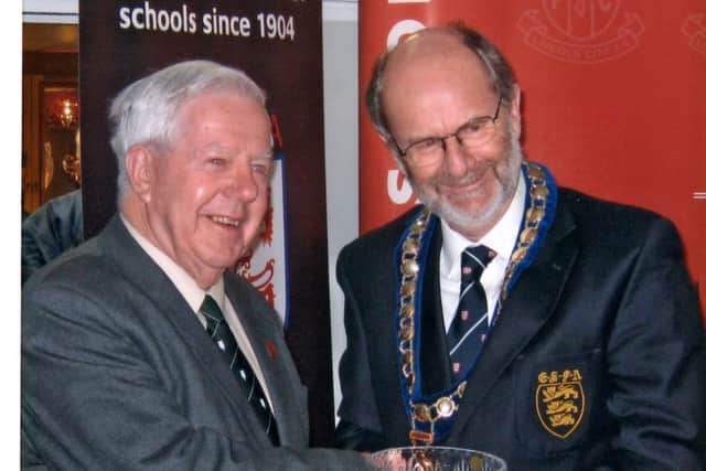 John Fowler (left) receives his 50 year service award from the English Schools FA.