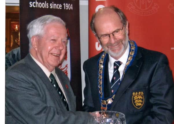 John Fowler (left) receives his 50 year service award from the English Schools FA.