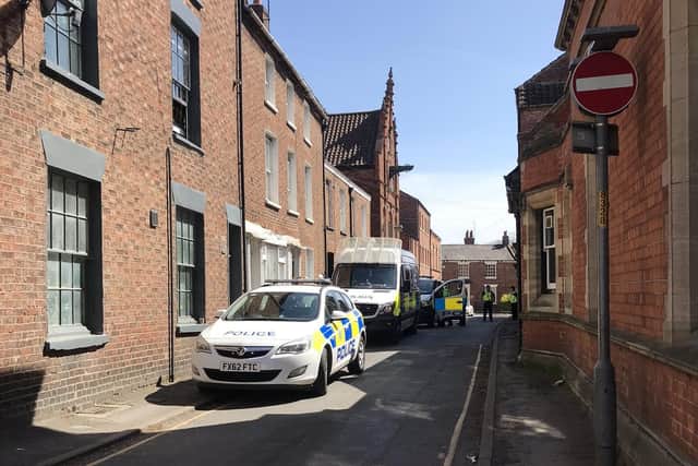 Police vehicles in the aftermath of the ABS incident.