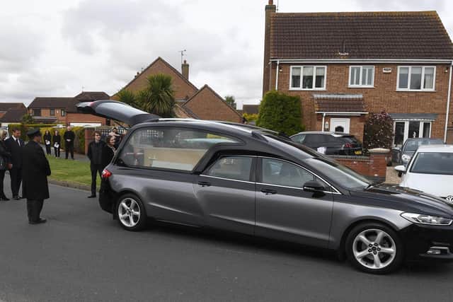 Family members pay their respects.