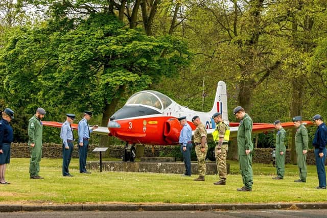 RAF College Cranwell personnel bow their heads for the minute's silence at 11am today for key workers who have died during the coronavirus pandemic. EMN-200428-153947001