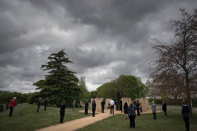 The minute's silence at Lincolnshire Police's memorial garden. EMN-200428-153958001