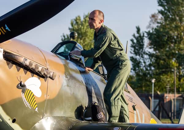Squadron Leader Mark ‘Disco’ Discombe, who flew the Hurricane over Colonel Tom Moore’s house, checks the aircraft before flight. Picture: LAC Iwan Lewis. EMN-200430-120100001