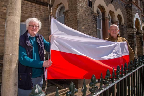Horncastle’s Town and County Councillor Bill Aron (left) joins Simon Elmer to hoist the Polish flag at the town’s War Memorial Hospital Centre on Sunday.