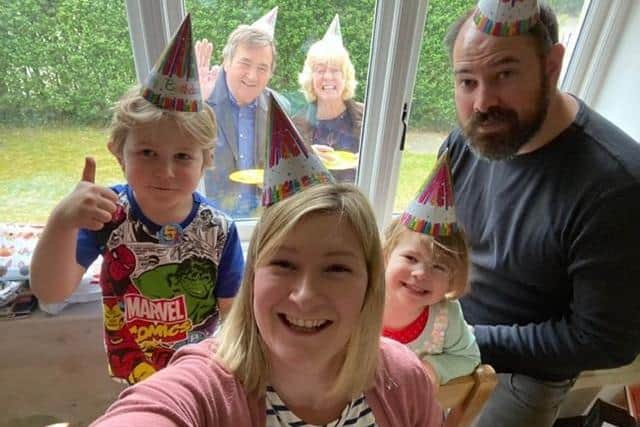 The Wharram family's birthday surprise. From left - Oliver, mum Beck, Freya and dad Chris, with grandparents John and Kim Janickyj in the window. EMN-200505-175753001