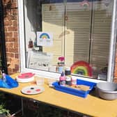 Liz Pearson's table full of materials outside The Glass Room for villagers wanting to create clay poppies for VE Day. EMN-200605-153016001