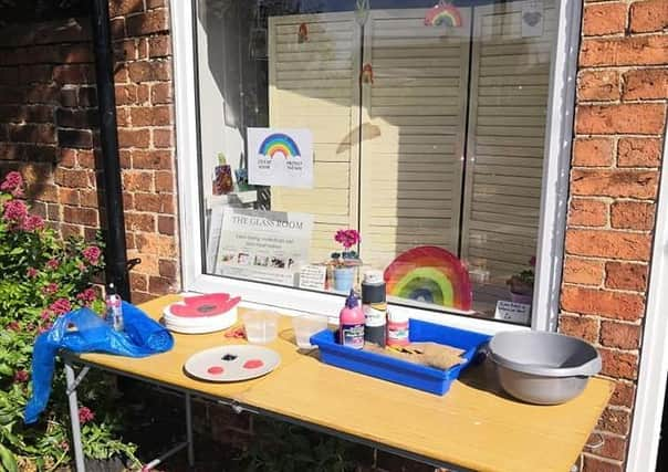 Liz Pearson's table full of materials outside The Glass Room for villagers wanting to create clay poppies for VE Day. EMN-200605-153016001