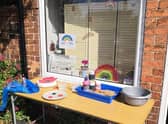 Liz Pearson's table full of materials outside The Glass Room for villagers wanting to create clay poppies for VE Day. EMN-200605-153016001