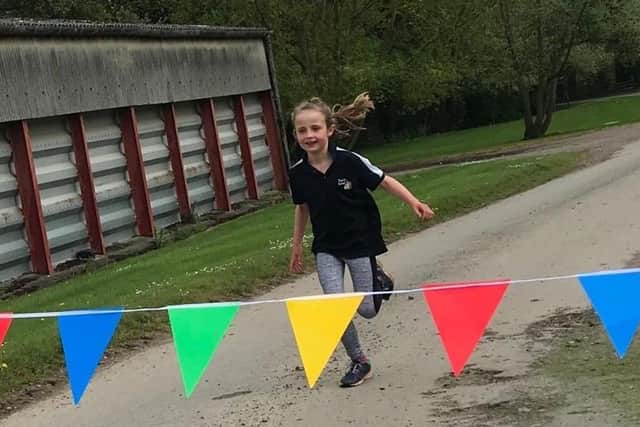 Tilly crossing the line to finish her marathon challenge EMN-200705-134813001