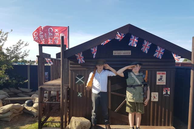 Jacob and Alfie outside their air raid shelter