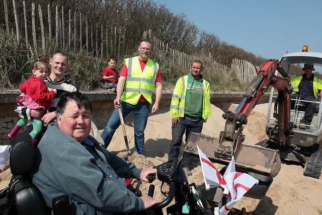 'Coastal Access for All' leading figure Paul Marshall surveys the work being undertaken by Morrison Groundwork on Sea View Walk, as volunteers continue to construct the record dragon on the beach.