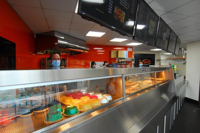 Andreas Pavlou behind the counter at Fillets wearing a face mask as part of their precautions. EMN-200514-110405001