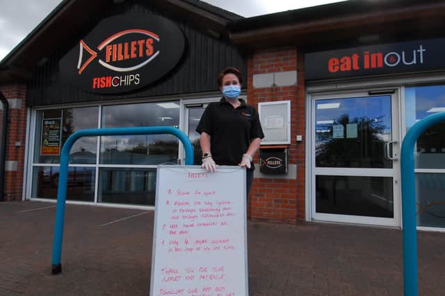 Open for business and the only chippy to deliver in town! Owner, Sam Pavlou with her board of guidance for customers entering Fillets. EMN-200514-110416001