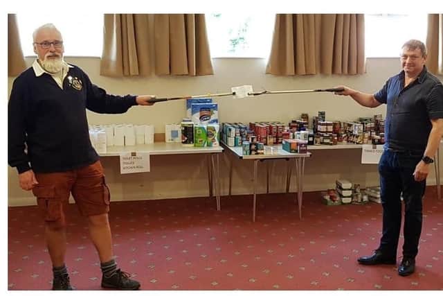 Lions president Andy Gutherson makes a safe distance presentation to group chairman Steve Critten. Photo courtesy of Caistor & District Lions