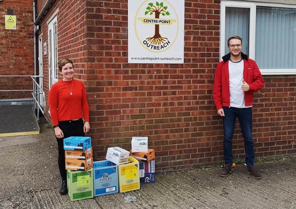 Dominic Solesbury, of the White Hart Hotel, Boston, is pictured handing over the surplus supplies to Centrepoint Outreach’s Kelly Reay.