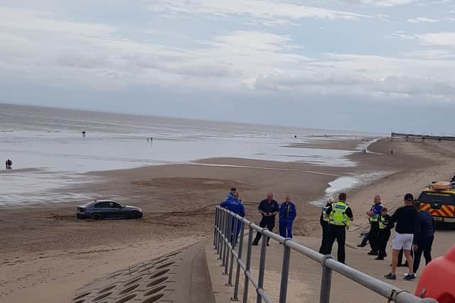 Emergency services at the scene of a car stuck on the beach in Skegness.